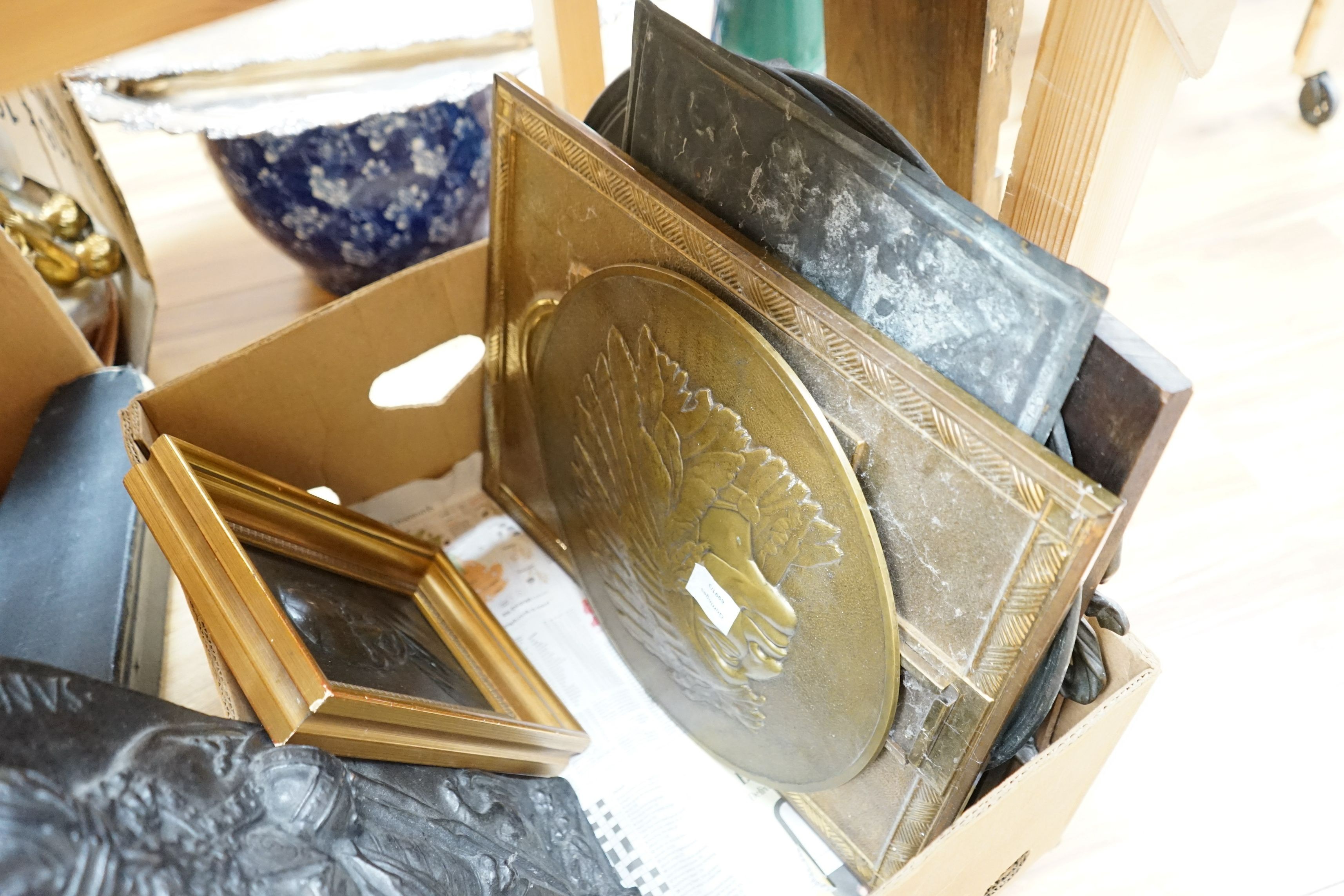 Nine relief plaques, a carved panel and a bronze style putti mounted on wooden panel